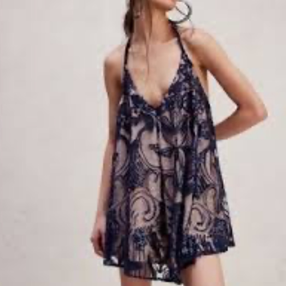 NWOT retail$168 size M Free People. Swinging’ It Romper with V neck-line.